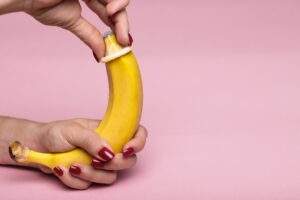 vegan condom being put on a banana