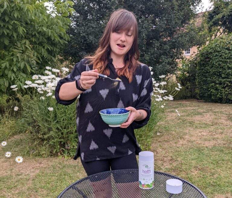 Alice attempting to sprinkle Hoffi over her bowl of vegan breakfast cereal