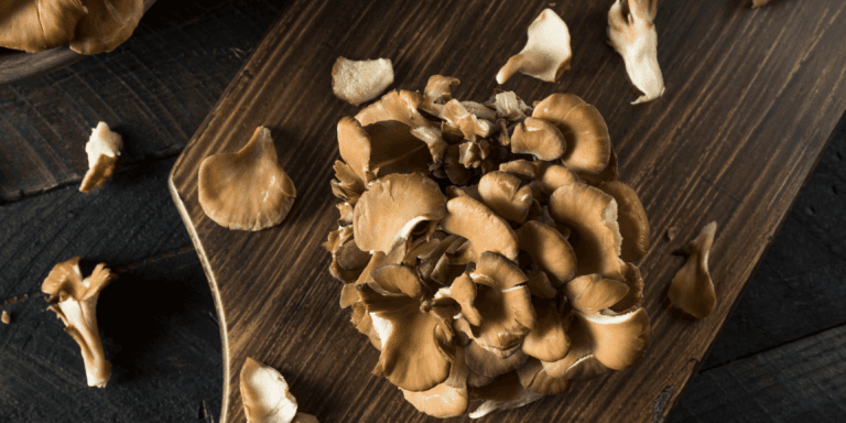 A chopping board with maitake mushrooms as a meat replacement