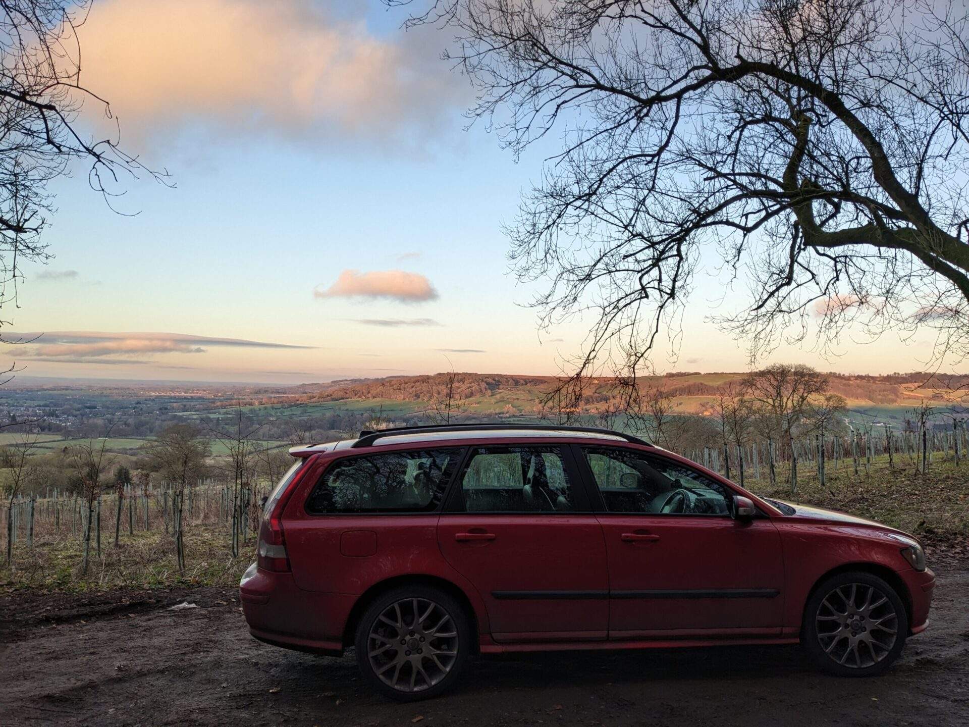 Gloucestershire countryside with my red Volvo parked in front of a stunning view