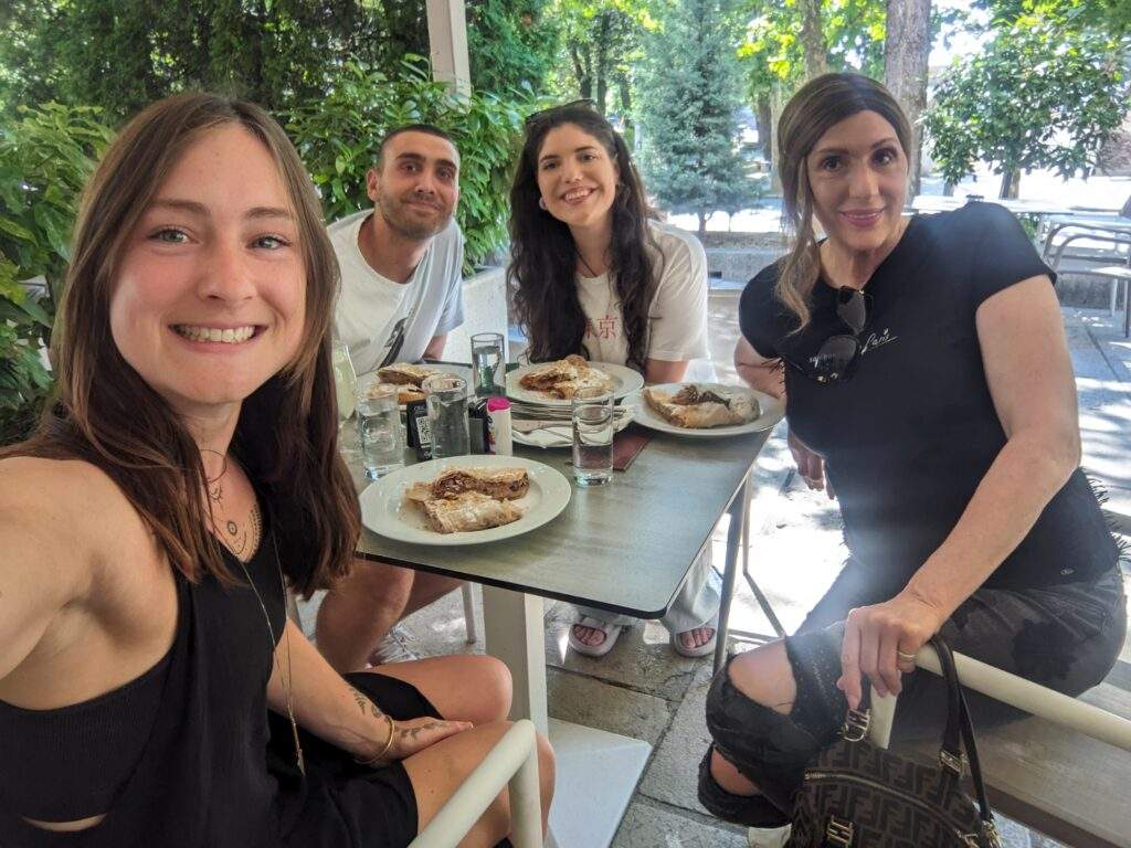 Alice and her friends taking a selfie before tucking into accidentally vegan pita of jabuka in a hotel restaurant in Niksic